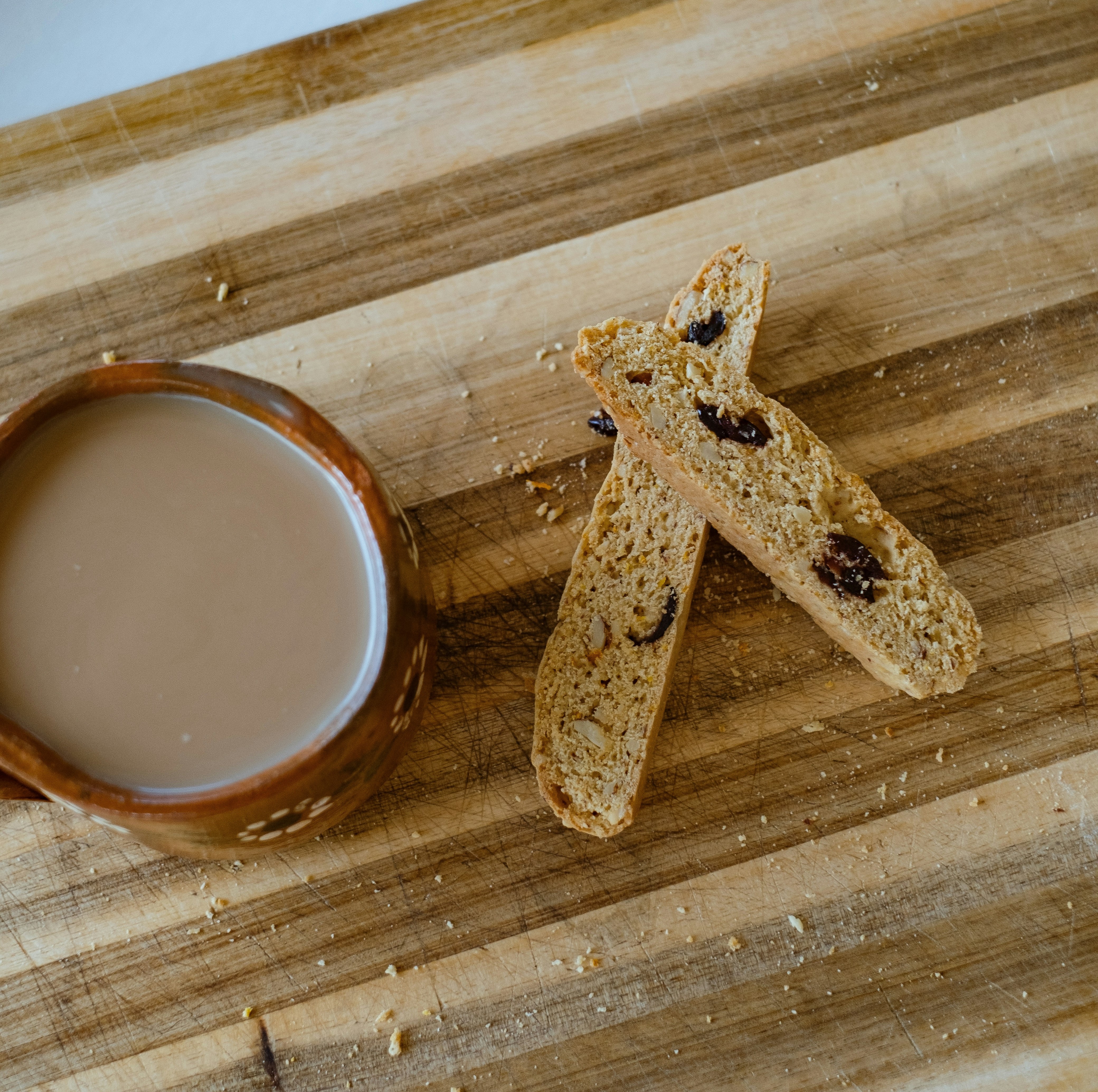  Two Sticks of Biscotti with a hot cup of coffee.